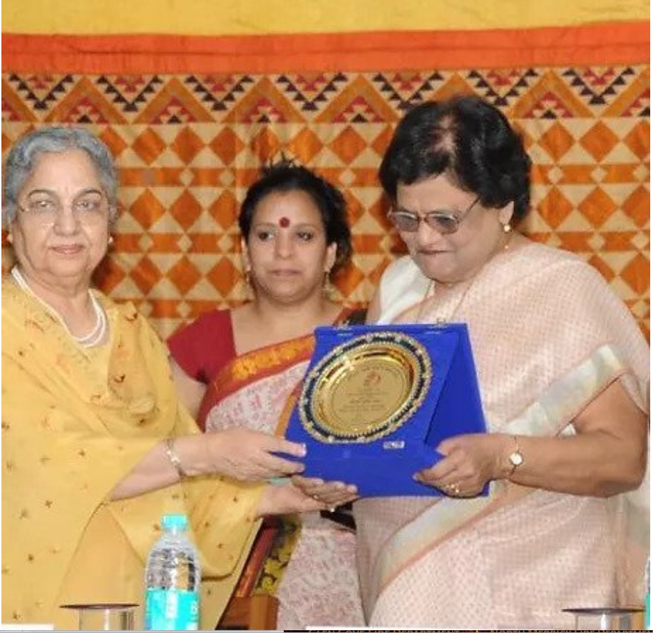 Krishna Lal receiving recognition connected to her Phulkari book from Gursharan Kaur